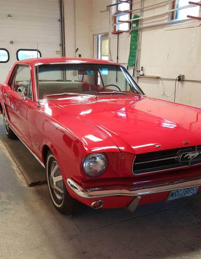 Red vintage for mustang in a garage
