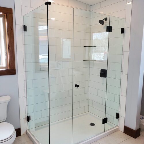 Image of a glass shower door install by Top Notch Custom Glass